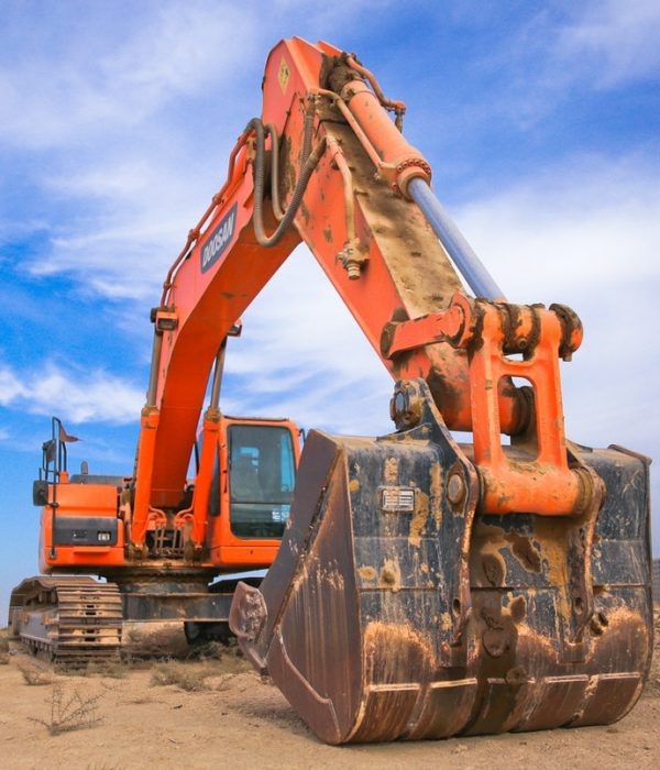 low-angle-photography-of-orange-excavator-under-white-clouds-1078884